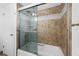 Bathroom with tiled shower and sliding glass door at 5130 Brittany S Dr # 505, St Petersburg, FL 33715