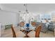 Dining area with glass-top table, wicker chairs, and a view into the living room at 5130 Brittany S Dr # 505, St Petersburg, FL 33715