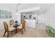 Dining area with glass-top table, wicker chairs, and adjacent kitchen at 5130 Brittany S Dr # 505, St Petersburg, FL 33715