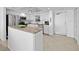 White kitchen with stainless steel appliances, granite countertops, and island at 5130 Brittany S Dr # 505, St Petersburg, FL 33715
