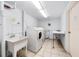 Laundry room with washer, dryer, sink, and folding table at 5130 Brittany S Dr # 505, St Petersburg, FL 33715