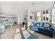 Living room with blue couch, natural light, and view of the adjacent kitchen at 5130 Brittany S Dr # 505, St Petersburg, FL 33715