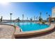 Inviting community pool with palm trees and waterfront access at 5130 Brittany S Dr # 505, St Petersburg, FL 33715