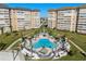 Community pool with lounge chairs and palm trees at a condo complex at 5130 Brittany S Dr # 505, St Petersburg, FL 33715