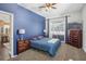 Comfortable bedroom with blue accent wall, carpeted flooring, and attached bathroom at 10014 Colonnade Dr, Tampa, FL 33647