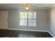 Living room featuring dark wood-look floors, ceiling fan, large window, and crown molding at 1020 85Th N Ave # 224, St Petersburg, FL 33702