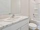 Clean bathroom with white marble countertop, sink, toilet, and shower at 10746 Hidden Banks Gln, Parrish, FL 34219