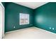 Bedroom with teal walls and window with shutters at 11032 Lynn Lake Cir, Tampa, FL 33625