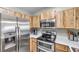 Kitchen boasts stainless steel appliances and wood cabinets at 1211 Coolridge Dr, Brandon, FL 33511