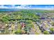 An aerial view of a residential neighborhood with houses, trees, and a nearby body of water at 154 81St N Ave, St Petersburg, FL 33702