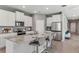 Modern kitchen with white cabinets, stainless steel appliances, and a large island with bar seating at 16018 10Th E Ave, Bradenton, FL 34212