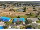 Aerial view of homes with blue tarps on roofs beside a golf course at 2701 Lancaster Dr, Sun City Center, FL 33573