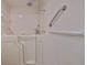 Bathroom with walk-in tub, tiled walls, and safety grab bars at 2701 Lancaster Dr, Sun City Center, FL 33573