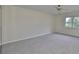 Empty bedroom with carpet and a large window overlooking the greenery at 2701 Lancaster Dr, Sun City Center, FL 33573
