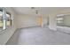 Large bedroom with plush carpeting and windows offering scenic views at 2701 Lancaster Dr, Sun City Center, FL 33573