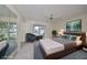 Virtually staged bedroom with modern furniture, large bed, and window view at 2701 Lancaster Dr, Sun City Center, FL 33573