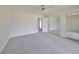 Spacious, carpeted bedroom with mirrored closet doors and neutral walls at 2701 Lancaster Dr, Sun City Center, FL 33573