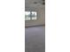Bedroom with gray carpeting, windows, and a ceiling fan at 2701 Lancaster Dr, Sun City Center, FL 33573