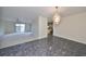 Dining area open to living room, with tile floor and chandelier at 2701 Lancaster Dr, Sun City Center, FL 33573