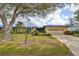 One-story home with attached garage, landscaping, and covered entryway at 2701 Lancaster Dr, Sun City Center, FL 33573
