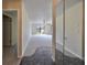 Foyer with tile and carpet flooring, mirrored closet, and view of the living area at 2701 Lancaster Dr, Sun City Center, FL 33573