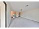 Living room with gray carpet and view of the kitchen and dining areas at 2701 Lancaster Dr, Sun City Center, FL 33573