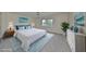 Staged main bedroom with white bedding, blue accents, and natural light at 2701 Lancaster Dr, Sun City Center, FL 33573