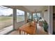 Bright sunroom with tile floor, ceiling fan, and golf course view at 2701 Lancaster Dr, Sun City Center, FL 33573