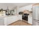 Kitchen with stainless steel appliances and wood-look tile floors at 2731 Logue Rd, Myakka City, FL 34251