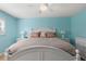 Bright bedroom with a king-size bed, white furniture, and light teal walls at 3014 W Helen Ave, Tampa, FL 33611