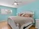 Bedroom with a king-size bed, white furniture, and light teal walls at 3014 W Helen Ave, Tampa, FL 33611