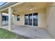 Covered back patio with ceiling fans and sliding glass doors at 442 Bahama Grande Blvd, Apollo Beach, FL 33572