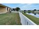 Backyard with canal view and white vinyl fence at 442 Bahama Grande Blvd, Apollo Beach, FL 33572