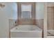 Bathroom with corner soaking tub and tile surround at 442 Bahama Grande Blvd, Apollo Beach, FL 33572
