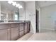 Double vanity bathroom with granite countertop, large shower, and separate tub at 442 Bahama Grande Blvd, Apollo Beach, FL 33572