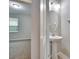 Modern powder room with pedestal sink and circular mirror at 442 Bahama Grande Blvd, Apollo Beach, FL 33572