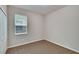 Well-lit bedroom featuring carpeted floor and window at 442 Bahama Grande Blvd, Apollo Beach, FL 33572