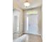 Front entry with tile floor, arched window, and white door at 442 Bahama Grande Blvd, Apollo Beach, FL 33572