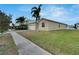 Side view of the house showcasing lawn and driveway at 442 Bahama Grande Blvd, Apollo Beach, FL 33572