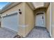 White two-car garage with paver driveway at 442 Bahama Grande Blvd, Apollo Beach, FL 33572