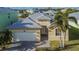 Single-Gathering house exterior with metal roof and two palm trees at 442 Bahama Grande Blvd, Apollo Beach, FL 33572