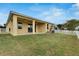 House exterior showcasing a covered patio and grassy yard at 442 Bahama Grande Blvd, Apollo Beach, FL 33572