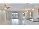 Open kitchen with island and view to backyard at 442 Bahama Grande Blvd, Apollo Beach, FL 33572