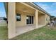 Covered patio with ceiling fan and sliding glass doors at 442 Bahama Grande Blvd, Apollo Beach, FL 33572