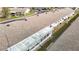 An aerial view showcasing the home's roof, Florida room, and surrounding community at 5316 Buttonwood Dr, New Port Richey, FL 34652