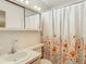 Bathroom with floral shower curtain and white vanity at 5316 Buttonwood Dr, New Port Richey, FL 34652