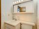 Bright bathroom with white vanity, mirror, and tiled walls at 5316 Buttonwood Dr, New Port Richey, FL 34652
