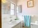Bright bathroom with white tile, vanity, and large mirror at 5316 Buttonwood Dr, New Port Richey, FL 34652