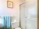 Simple bathroom with tiled walls, shower, and white fixtures at 5316 Buttonwood Dr, New Port Richey, FL 34652