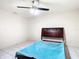Unfurnished bedroom with teal bedding and ceiling fan at 5316 Buttonwood Dr, New Port Richey, FL 34652